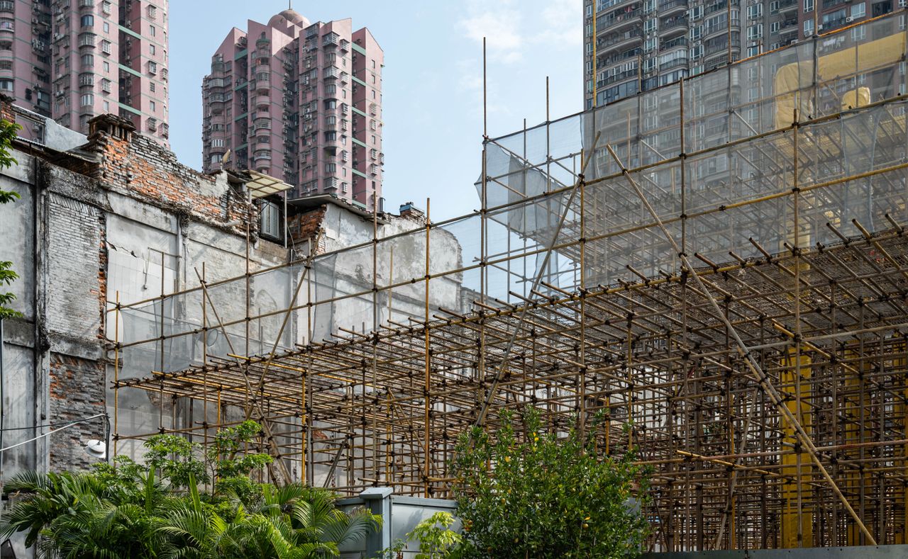 Bamboo scaffolding at a construction site in Guangzhou with highrise buildings in the background.